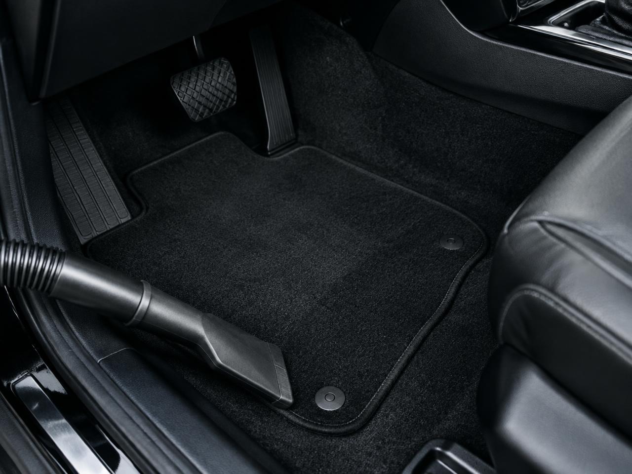 Vehicle carpet and floor mats vacuumed clean during an interior deep clean